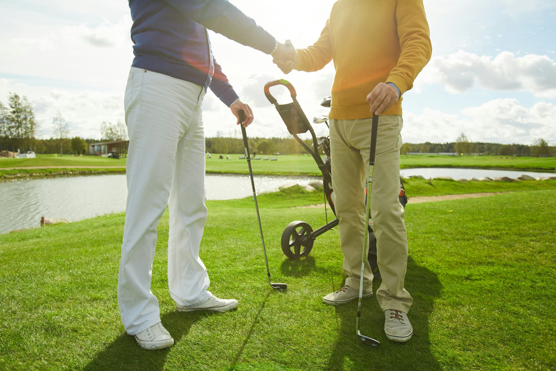 Two golfers shaking hands on the course